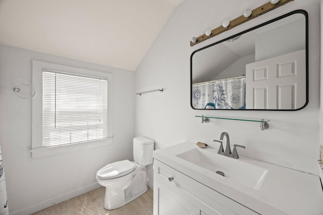 bathroom featuring vanity, toilet, a shower with shower curtain, wood finished floors, and vaulted ceiling