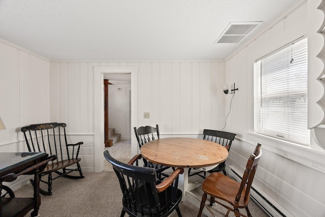 dining area featuring visible vents, light carpet, stairway, and a decorative wall
