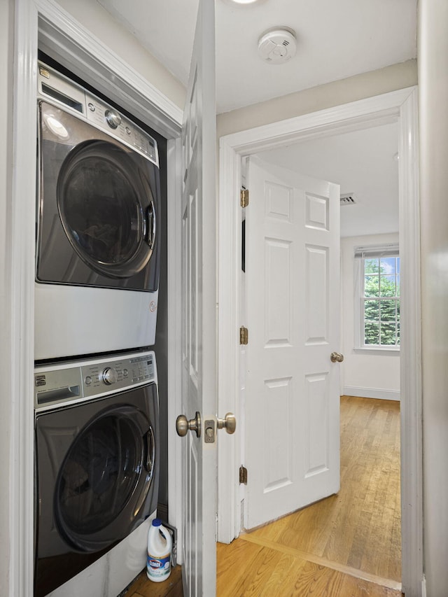 9 Cogswell Path, West Yarmouth, MA 02673 - laundry area with estacked washer and dryer and light wood-type flooring