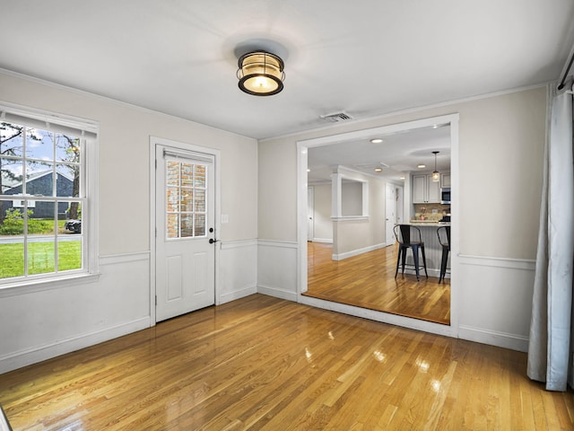 9 Cogswell Path, West Yarmouth, MA 02673 - foyer featuring light wood finished floors, baseboards, and crown molding