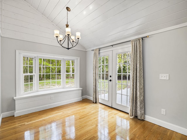 9 Cogswell Path, West Yarmouth, MA 02673 - unfurnished dining area featuring lofted ceiling, french doors, plenty of natural light, a chandelier, and wood finished floors