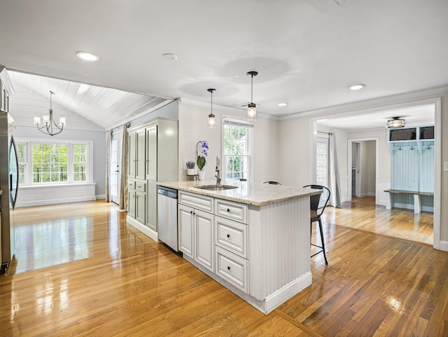 9 Cogswell Path, West Yarmouth, MA 02673 - kitchen with stainless steel dishwasher, a sink, light wood-style floors, healthy amount of natural light, and lofted ceiling