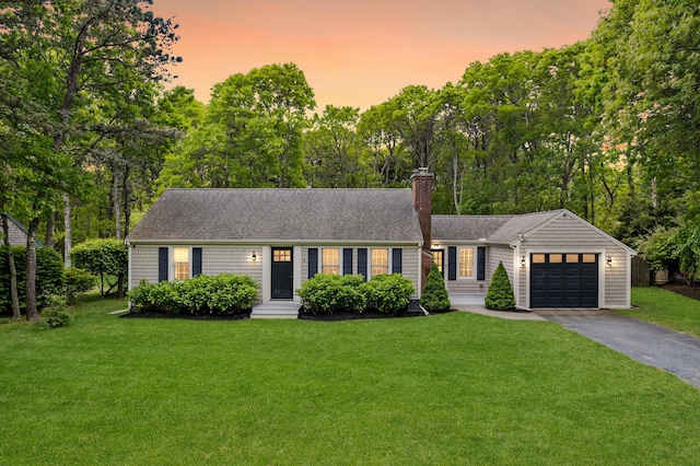 9 Cogswell Path, West Yarmouth, MA 02673 - view of front facade with asphalt driveway, a garage, entry steps, and a yard