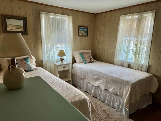 bedroom featuring wooden walls