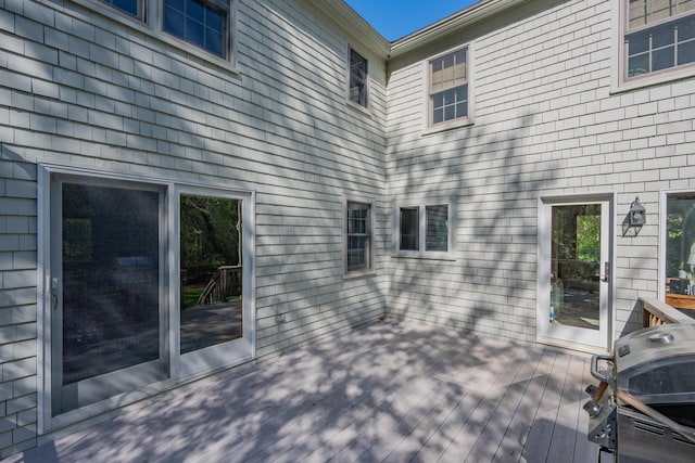 wooden deck featuring a grill