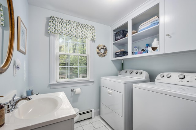 laundry area with a baseboard radiator, washer and clothes dryer, light tile patterned flooring, and baseboards