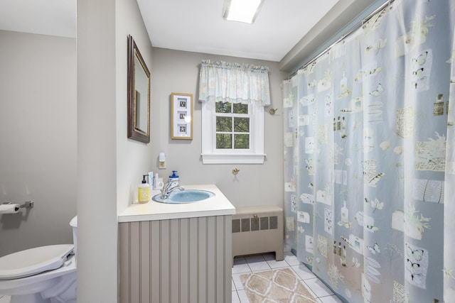 bathroom featuring radiator, toilet, tile patterned floors, vanity, and a shower with curtain
