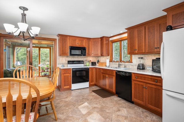 kitchen featuring black appliances, light countertops, a chandelier, tasteful backsplash, and recessed lighting