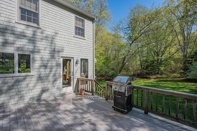 wooden deck featuring a lawn and area for grilling