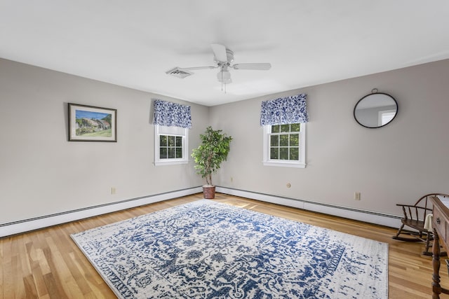 unfurnished room with plenty of natural light, ceiling fan, a baseboard heating unit, and baseboards