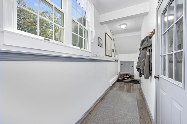 corridor with wood finished floors and baseboards