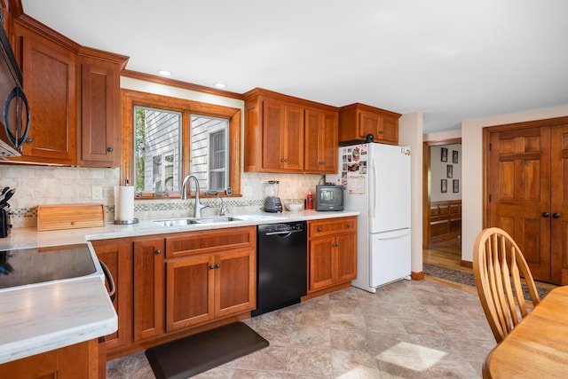 kitchen with black appliances, a sink, light countertops, and backsplash
