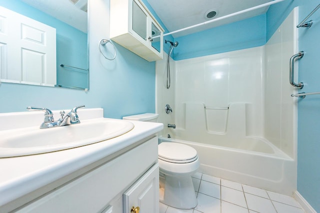 bathroom featuring tile patterned floors, shower / bathtub combination, toilet, and vanity