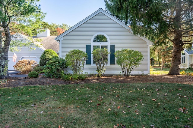 view of side of home with a lawn