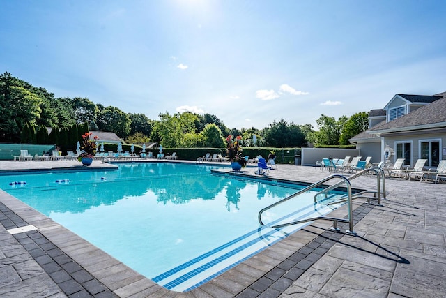 community pool featuring a patio area and fence