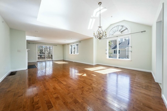 unfurnished room with a chandelier, baseboards, and wood-type flooring