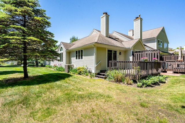 9 Longwood Rd, Mashpee, MA 02649 - back of house with a yard, a wooden deck, a chimney, and cooling unit