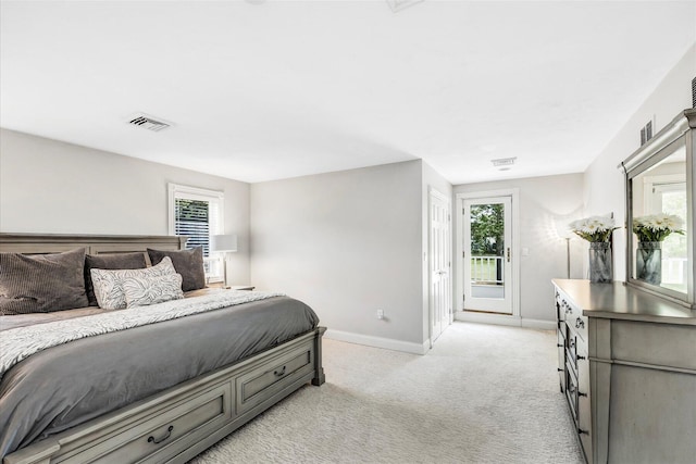 bedroom with light colored carpet, visible vents, access to exterior, multiple windows, and baseboards