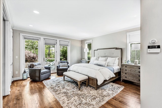 bedroom with crown molding, access to exterior, wood finished floors, and baseboards