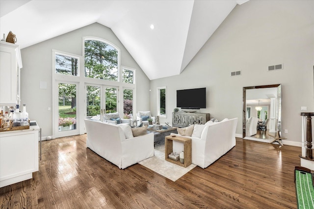 living room with high vaulted ceiling, visible vents, baseboards, and dark wood finished floors