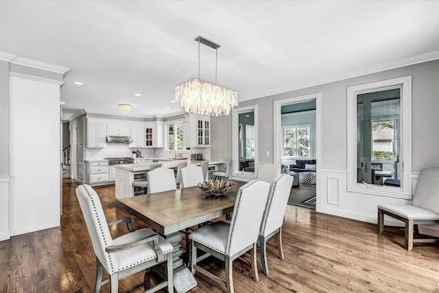 dining space with plenty of natural light, a chandelier, and wood finished floors
