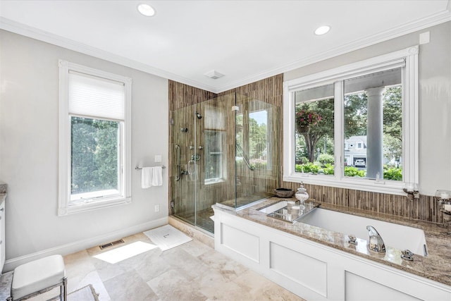 bathroom featuring a bath, a stall shower, visible vents, and a wealth of natural light