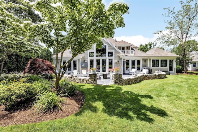 back of property featuring a patio area and a yard