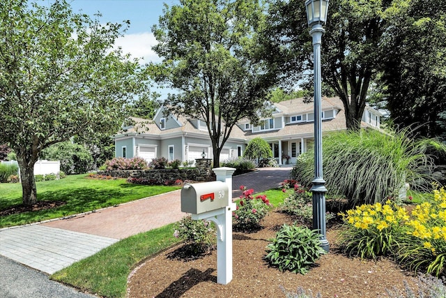 view of front of home featuring a garage and a front yard