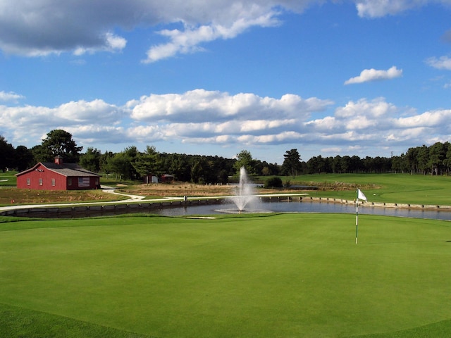 surrounding community with a water view and view of golf course