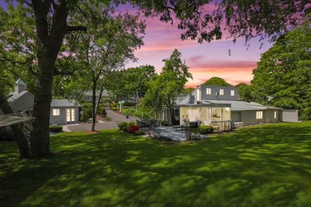 130 Wimbledon Dr, West Yarmouth, MA 02673 - back of house with a lawn