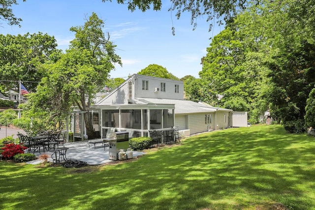130 Wimbledon Dr, West Yarmouth, MA 02673 - rear view of house with a sunroom, a patio area, a lawn, and a shingled roof