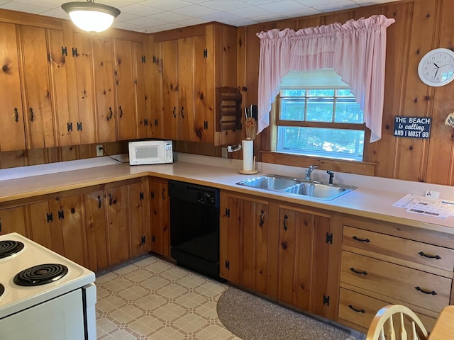 131 Forest Beach Rd, South Chatham, MA 02659 - kitchen featuring white appliances, wood walls, brown cabinetry, and light countertops