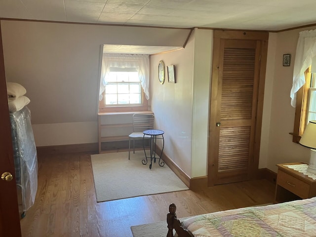 131 Forest Beach Rd, South Chatham, MA 02659 - bedroom featuring wood finished floors, crown molding, and a closet