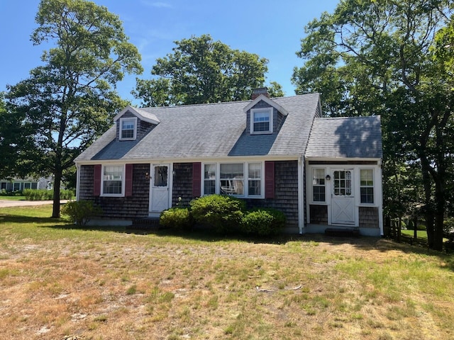 131 Forest Beach Rd, South Chatham, MA 02659 - new england style home with a front yard and roof with shingles