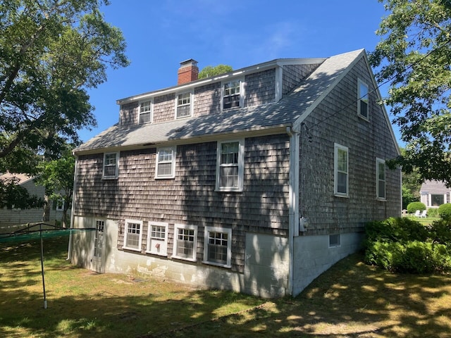 131 Forest Beach Rd, South Chatham, MA 02659 - rear view of house featuring a chimney, a lawn, and a shingled roof