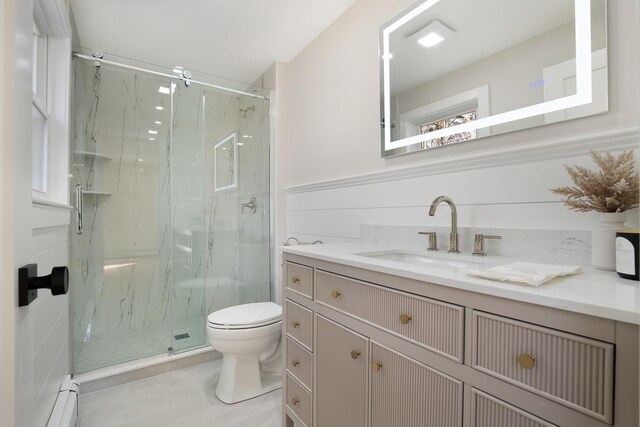 bathroom featuring a marble finish shower, toilet, vanity, and a baseboard radiator