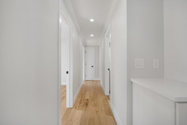 corridor featuring recessed lighting, light wood-style flooring, attic access, and baseboards