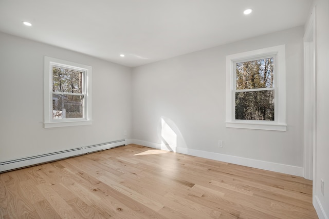 unfurnished room featuring baseboard heating, recessed lighting, baseboards, and wood finished floors