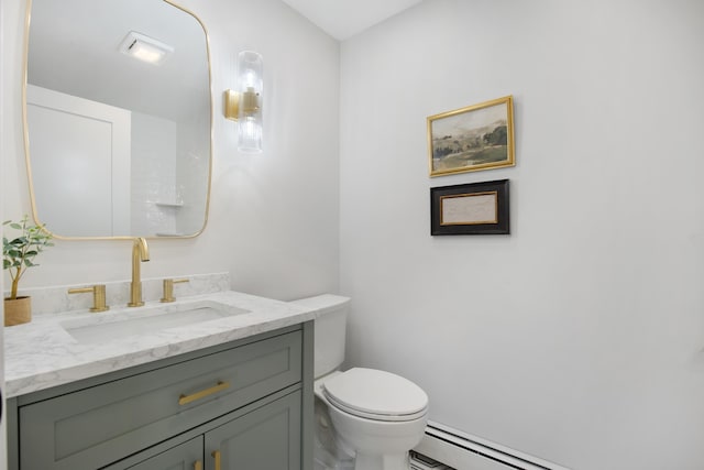 bathroom with a baseboard heating unit, toilet, and vanity