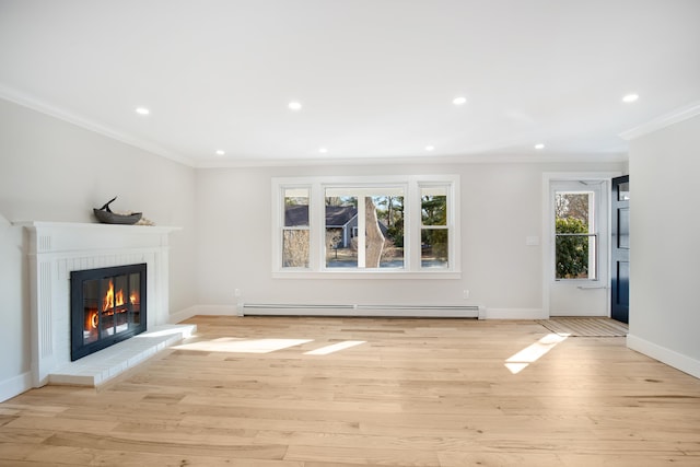 unfurnished living room featuring light wood finished floors, a baseboard heating unit, baseboards, crown molding, and a fireplace