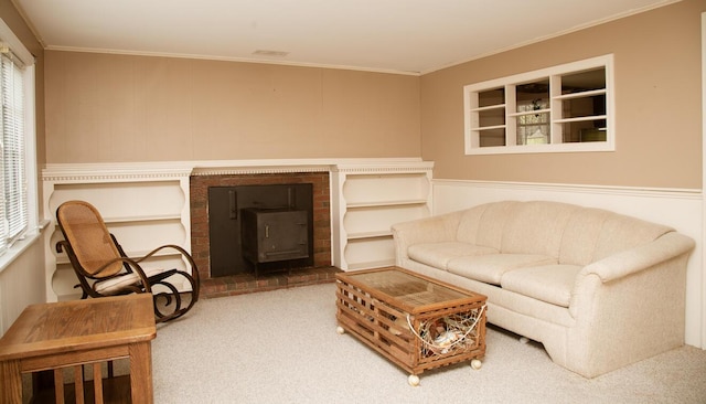 living area featuring ornamental molding, carpet flooring, a healthy amount of sunlight, and a brick fireplace