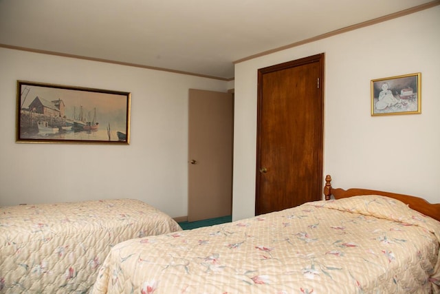 bedroom with crown molding and a closet