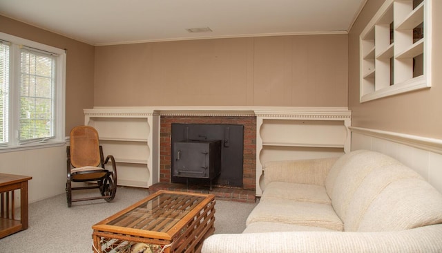 carpeted living room featuring a wood stove, ornamental molding, and a wainscoted wall