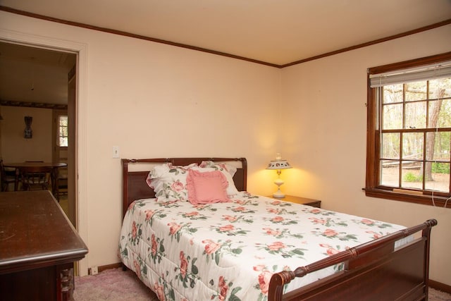 carpeted bedroom featuring ornamental molding and multiple windows