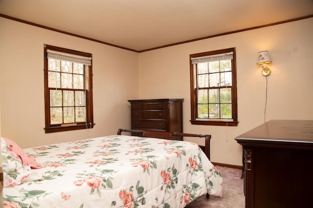 carpeted bedroom with baseboards and ornamental molding