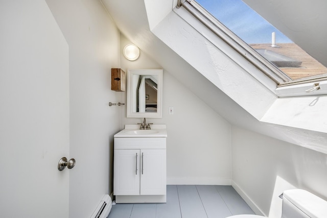 143R Bradford Street Ext Unit 2, Provincetown, MA 02657 - bathroom with toilet, vanity, vaulted ceiling, a baseboard heating unit, and tile patterned flooring