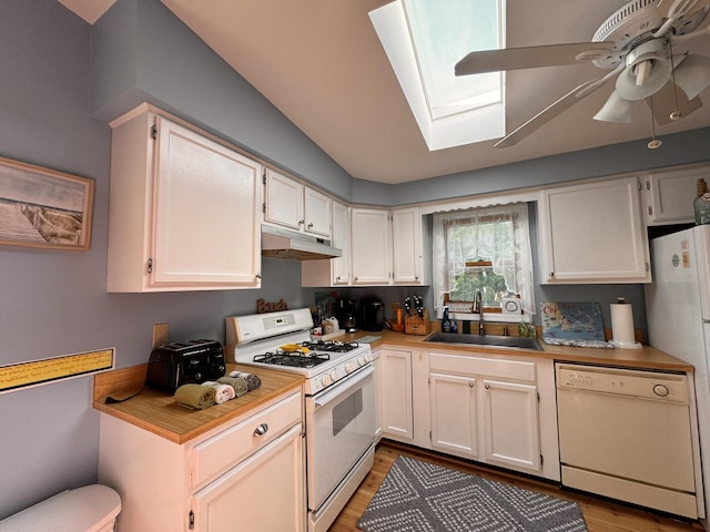 4 Coffey Ln, Dennis Port, MA 02639 - kitchen featuring white appliances, under cabinet range hood, a skylight, light wood finished floors, and a ceiling fan