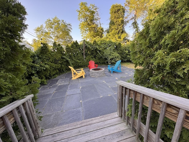 4 Coffey Ln, Dennis Port, MA 02639 - wooden deck with an outdoor fire pit and a patio area