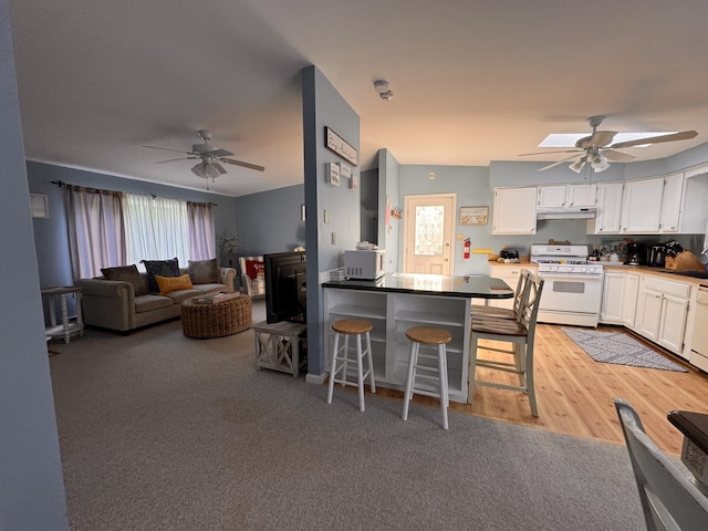 4 Coffey Ln, Dennis Port, MA 02639 - kitchen with white appliances, a ceiling fan, white cabinetry, and under cabinet range hood