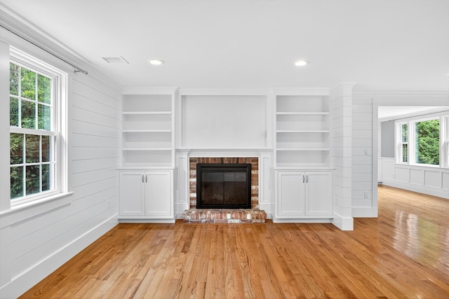 28 Stoney Cliff Rd, Centerville, MA 02632 - unfurnished living room featuring light wood-type flooring, built in shelves, a fireplace, crown molding, and recessed lighting
